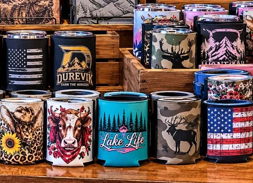 Flag koozies, tumblers and coasters on the shelf in our shop