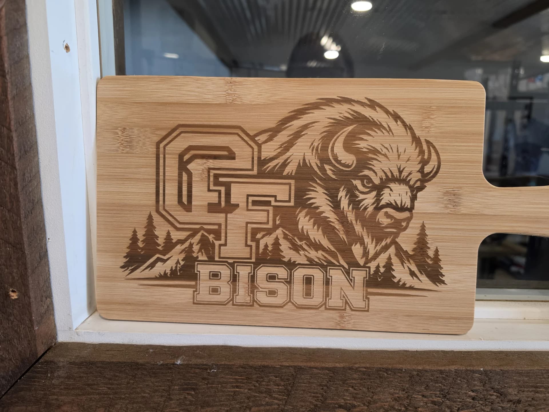 Bamboo paddle board laser engraved with the Great Falls Bison mark