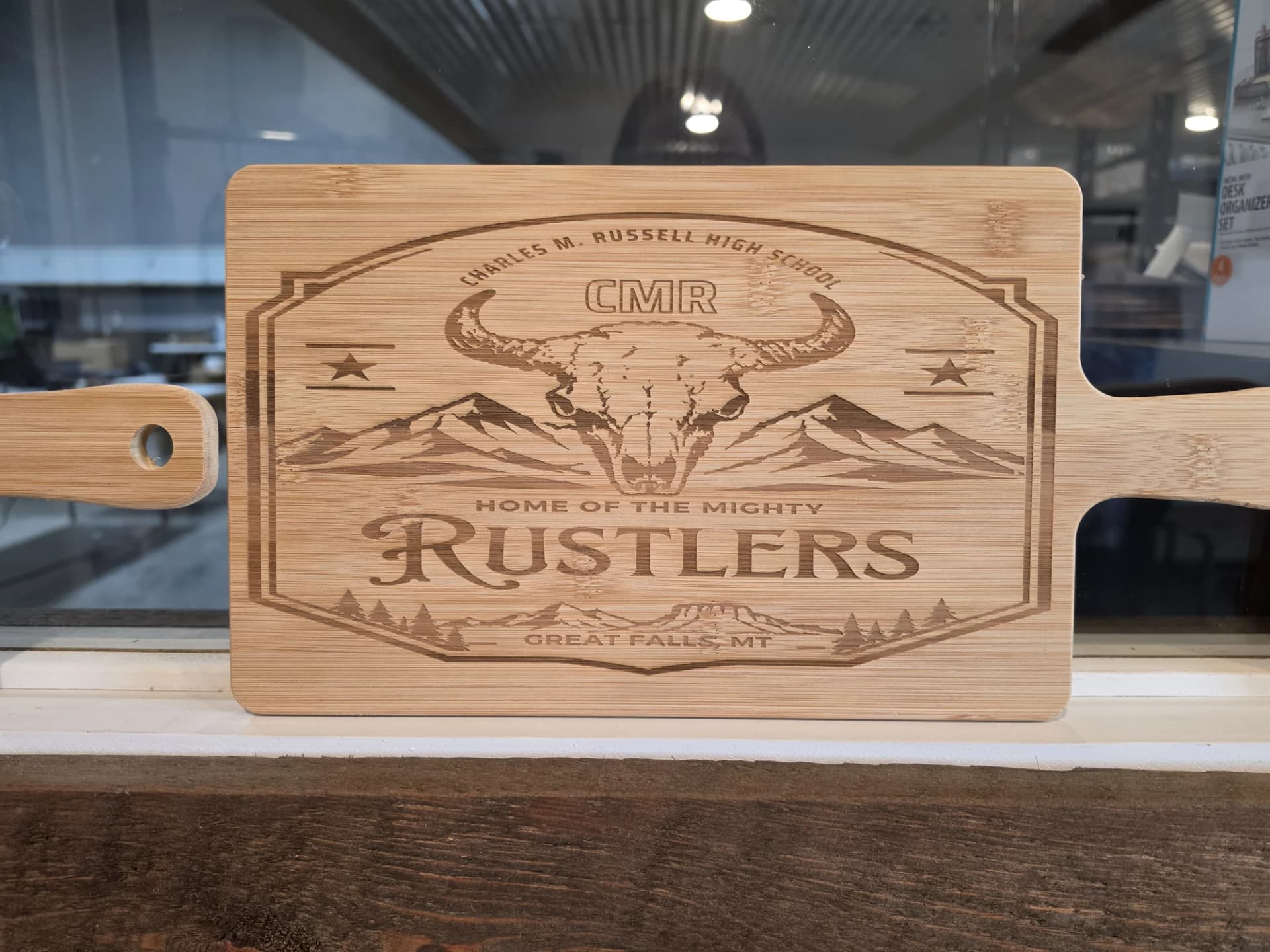 Bamboo paddle board laser engraved with the CMR Rustlers mark