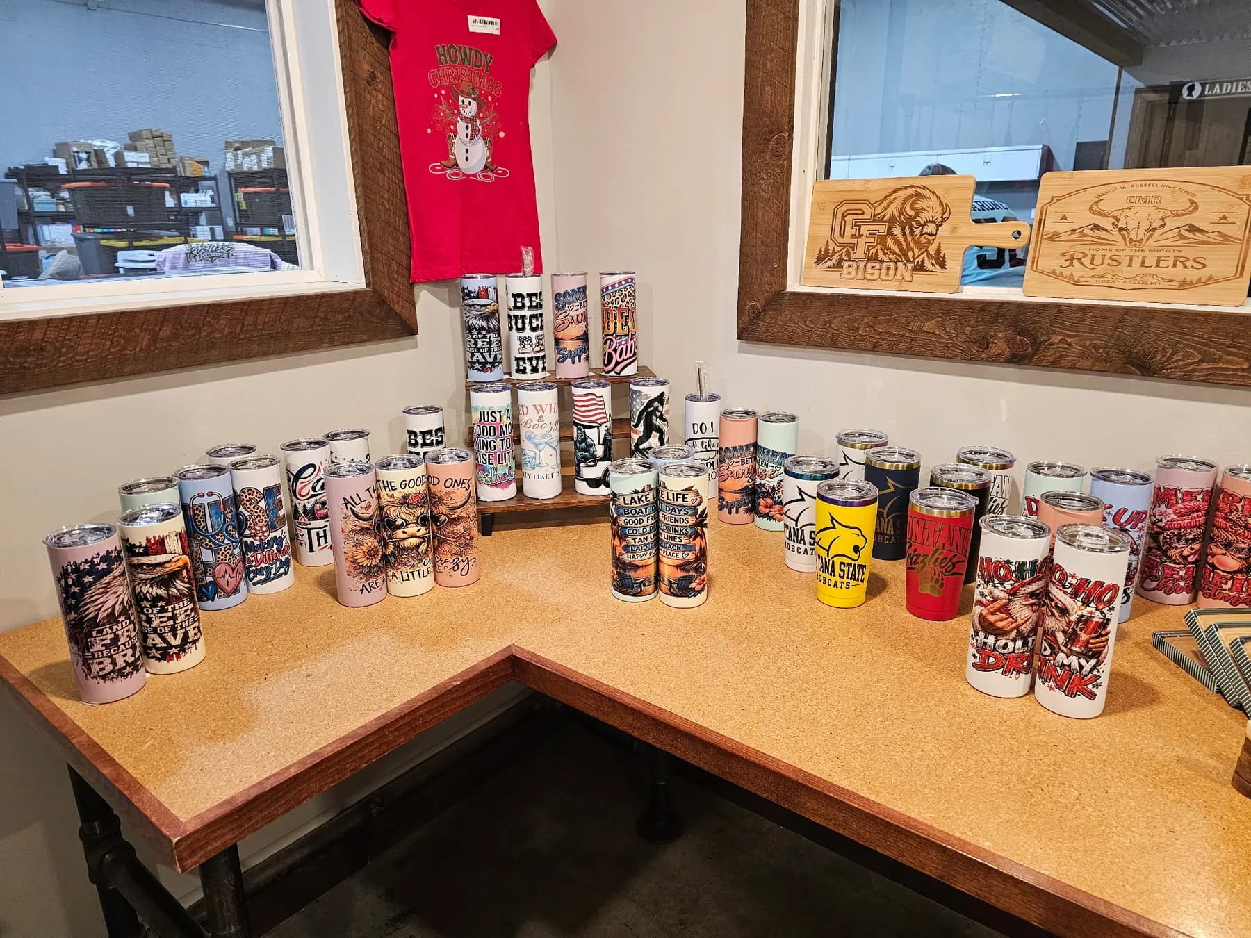 Full-wrap tumblers lined up on the front counter in our shop